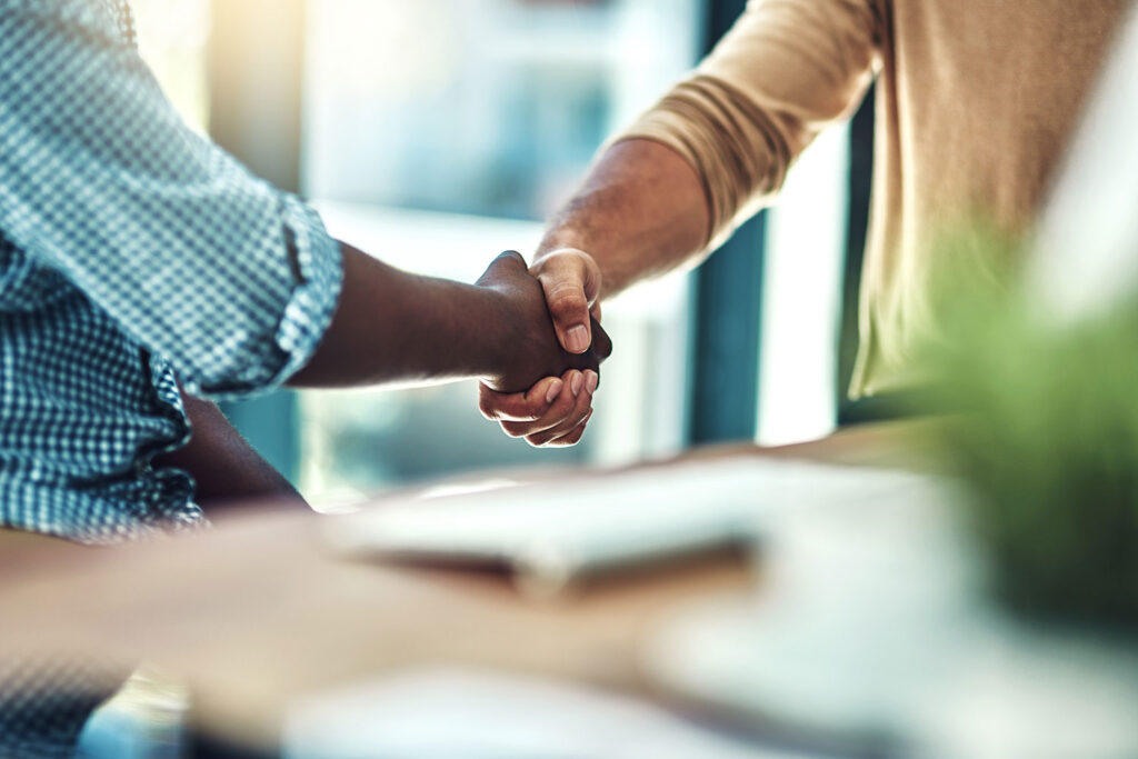 Two people agreeing and shaking hands